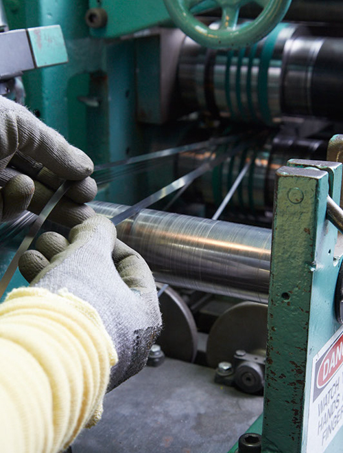 Inspecting metal running through slitter