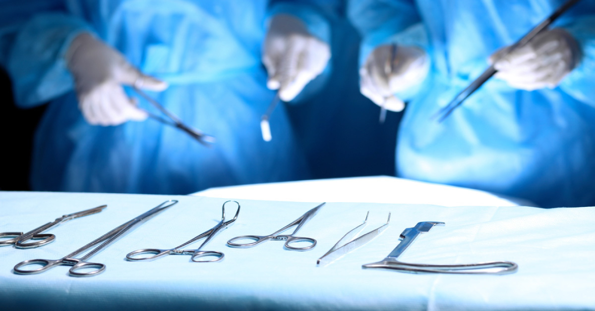 Steel medical instruments surgical tools on table while doctors operating